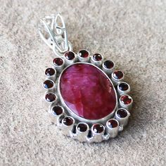 "Make a statement with this elegant hand-crafted semi-precious pendant which features gorgeous faceted red Garnet & Ruby.  Stone: Ruby & Garnet Colour: Red Metal: 100% Solid Sterling Silver Pendant Size: 3 x 2.5 (Excluding Bail) Chain: 18\" solid sterling silver Materials: Each one-of-a-kind piece of jewellery is lovingly hand crafted using top quality semi-precious natural gemstones and solid 925 sterling silver, so that you can treasure your piece for a lifetime.  Gift Boxes: each unique piece Silver Gift Box, Ruby Stone, Red Ruby, Colour Red, Red Garnet, Stone Pendant, Stone Pendants, Gift Boxes, Solid 925 Sterling Silver