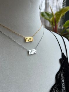 Introducing our 11:11 Necklace - Your Wishes, Your Way! Elevate your style with our exquisite 11:11 Necklace, plated in your choice of 18K White or Yellow Gold over durable Stainless Steel. Beyond its elegant design, this necklace features an adjustable 16-18 inch chain, allowing you to customize the length to your liking.  Embrace the powerful symbolism of 11:11, a timeless reminder that your wishes hold the key to your dreams.  But that's not all - our necklace boasts the benefits of stainless steel, offering you durability, resistance to tarnish, and a hypoallergenic quality, ensuring it remains as radiant as your dreams even with everyday wear.  Choose your preferred color, and let this elegant necklace become a meaningful part of your style. Make a wish, wear it proudly, and let it re 11 11 Necklace, Meaningful Necklaces, Meaningful Necklace, Hypoallergenic Jewelry, Elegant Necklace, Angel Numbers, Elegant Necklaces, Make A Wish, 11 11