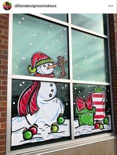 a window decorated with snowmen and presents