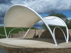 a large white canopy sitting on top of a cement slab