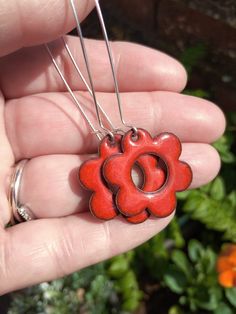 Red enamel daisy flower earrings. These enamelled earrings have be handcrafted by torch firing fine glass enamel powder onto copper. They are counter enamelled on the back for comfort and durability. The earring hooks are made of sterling silver.  The size of the enamel flower is 25mm Please note that enamel jewellery can come with slight colour variations, the differences in colour come from the varying thickness of glass as the powder is hand sifted, along with the different colours produced f Nickel-free Enamel Flower Earrings Gift, Gift Nickel-free Enamel Flower Earrings, Flower-shaped Enamel Flower Earrings For Gift, Enamel Flower Earrings For Gift, Orange Enamel Earrings As A Gift, Orange Enamel Earrings For Gift, Orange Enamel Earrings For Gifts, Handmade Enamel Flower Shaped Earrings, Flower Shaped Enamel Earrings For Gift