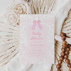 a baby shower is shown on top of a wicker basket with beads and flowers