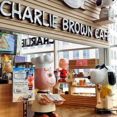 there is a statue of charlie brown cafe in front of the store