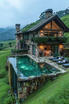 a house with a swimming pool in the middle of it's lawn and grass covered roof