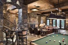 a pool table and some chairs in a room