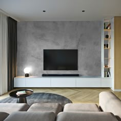 a living room with a large tv on the wall