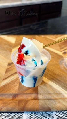 an ice cream sundae with red, white and blue toppings on a cutting board