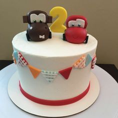 a birthday cake with two little monkeys on top