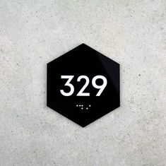 a black and white sign on the side of a building that reads 329,