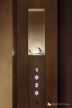 an illuminated door with a bird sitting on top of it and the numbers 10 20 are lit up