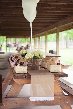 the table is set up with white flowers and burlocks