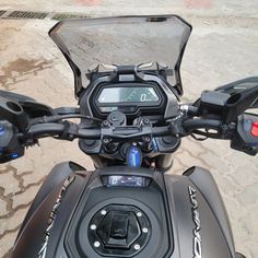 the front view of a motorcycle with its instrument on it's handlebars