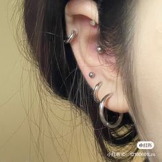 a woman with three piercings on her ear