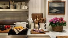 the kitchen counter is covered with pots, pans and other cooking utensils