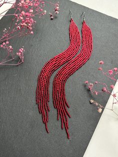 Long Red Beaded Fringe Earrings Add a vibrant touch to your outfit with these stylish long red beaded earrings. Handcrafted, these earrings captivate with their rich red color and elegant fringe, adding dynamism and lightness. These earrings are perfect for any occasion, whether it's a casual day out or an evening event. Lightweight and comfortable to wear, they will become your favorite accessory. Features: Lightweight and comfortable to wear. Unique design. Perfect gift. Made from Czech beads. Hypoallergenic clasp. Length 9 inches (23cm). Width 0.5 inches (1.5cm). If you want these earrings in a different color, write to me and I will be happy to make them for you. Elegant Red Tassel Drop Earrings, Handmade Red Tassel Earrings, Elegant Style, Handmade Elegant Red Tassel Earrings, Elegant Red Tassel Earrings As Gift, Elegant Handmade Red Tassel Earrings, Elegant Red Handmade Tassel Earrings, Elegant Red Tassel Earrings For Gift, Red Long Drop Jewelry For Party, Party Beaded Long Drop Earrings