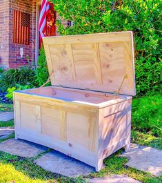 a large wooden chest sitting in the grass