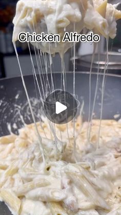 pasta being cooked in a pan with chicken alfredo