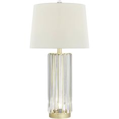 a table lamp with a white shade on the top and gold trimming around it