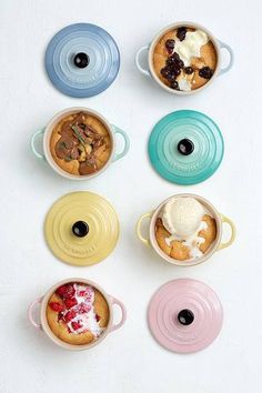 there are many different desserts in the dishes on this white table top, including cookies and ice cream