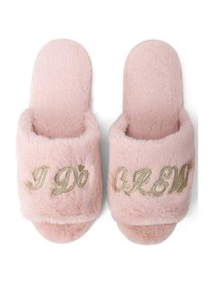 a pair of pink slippers with gold lettering