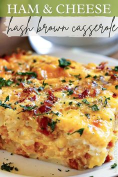 ham and cheese hashbrown casserole on a white plate with parsley