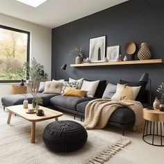 a living room filled with lots of furniture next to a large window and potted plants