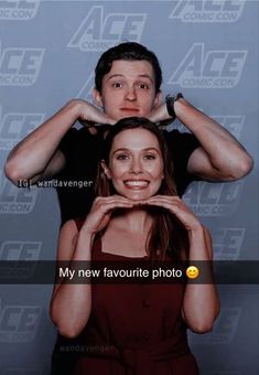 a man standing next to a woman in front of a blue wall with the caption my new favorite photo