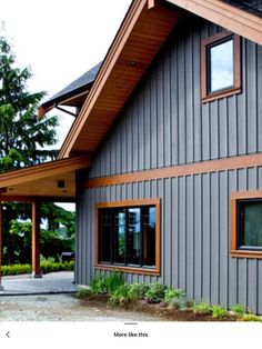 a gray house with wood trim and windows