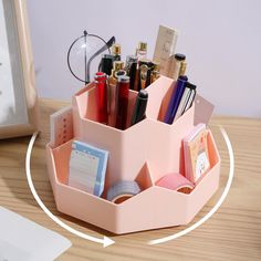 a pink desk organizer with pens and pencils