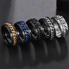 five different types of rings with chains on each one and blue, black, yellow or silver