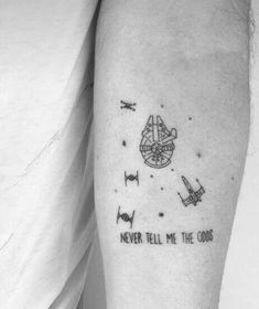 a man with a tattoo on his arm that says never tell me the odds and an airplane