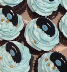 cupcakes with blue frosting and black decorations