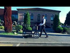 a man walking down the street next to a bike