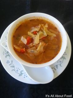 a white bowl filled with soup on top of a table