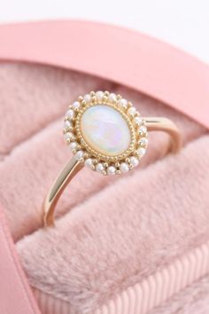 This vintage opal ring is absolutely gorgeous #opalring #vintagering #goldring Opal Pearl Ring, Opal Ring With Diamonds, Opal Wedding Ring Vintage, Pearl And Opal Ring, Vintage Opal Engagement Rings, Vintage Engagement Rings Opal, Oval Pearl Gemstone Ring For Anniversary, Gold Oval Opal Ring With Stone Setting, Pearl And Opal Engagement Ring