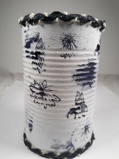 a white vase with black designs on it