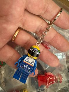 a hand holding a lego minifigure key chain