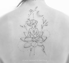 the back of a woman's neck with a lotus tattoo on her left shoulder