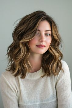 A deep side part is a simple yet effective way to change up your look if you have thick, wavy hair. Parting your hair deeply to one side can add volume and dimension, giving your waves a new level of sophistication. Medium Thick Wavy Haircut, Hairstyles With Natural Wavy Hair, Fall Hair Side Part, Medium Wavy Hair Side Part, Wavy Lob Hairstyles Mid Length, Smooth Waves Hair, Mid Length Thick Wavy Hair, Curly One Length Haircut, Hair Style 2024 Girl Medium