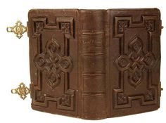 an old leather book with ornate designs on it