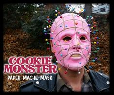 a man wearing a pink mask with sprinkles on it