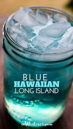 a blue hawaiian long island drink in a mason jar with ice cubes on the rim