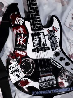 an electric bass guitar with stickers on it