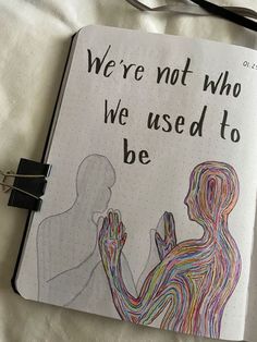 an open notebook with the words we're not who we used to be