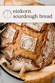 a loaf of sourdough bread sitting on top of a white plate with the words enkorn sourdough bread above it