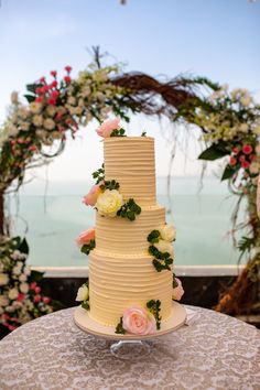 a three tiered wedding cake with flowers on it