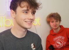 two young men sitting next to each other