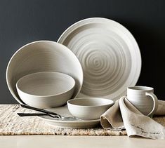 a white dinnerware set on a place mat