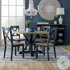 a dining room table with chairs and a chandelier