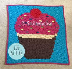 a crocheted blanket with an ice cream cone on it and the words smileygoose